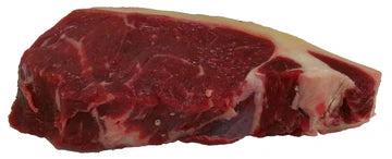 Raw Mother Acres strip steak with visible marbling on a white background
