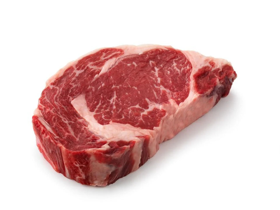 Raw  Mother Acres ribeye steak with marbling on a white background